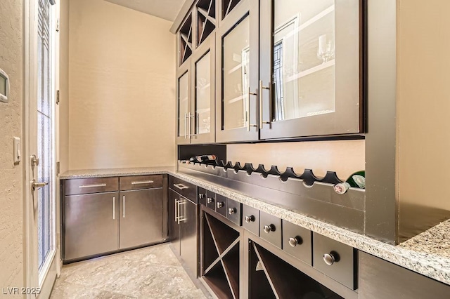 kitchen featuring glass insert cabinets and dark brown cabinets