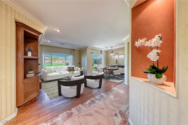 living area with ornamental molding and baseboards