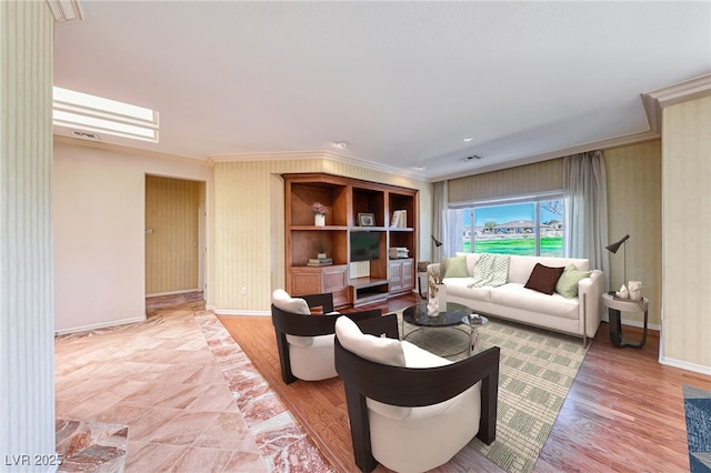 living room with a skylight, baseboards, light wood-style floors, and ornamental molding