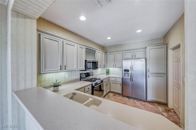 kitchen with recessed lighting, a sink, visible vents, light countertops, and appliances with stainless steel finishes