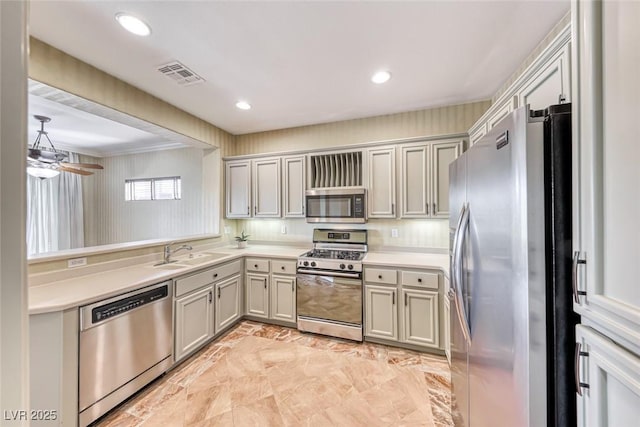 kitchen featuring visible vents, appliances with stainless steel finishes, light countertops, a sink, and recessed lighting