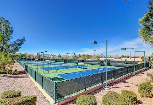 view of tennis court featuring fence