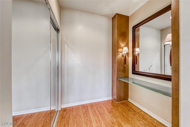 interior space with baseboards and wood finished floors