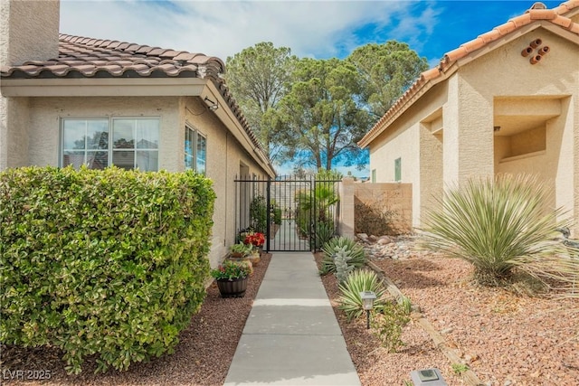 view of home's exterior with a tile roof and stucco siding