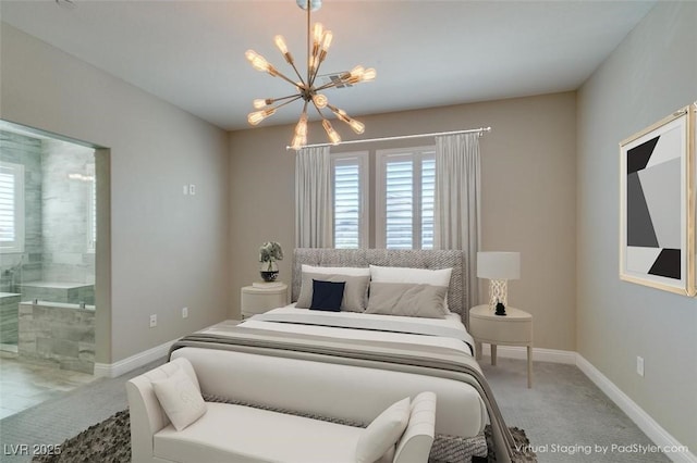 carpeted bedroom with baseboards, a chandelier, and ensuite bathroom