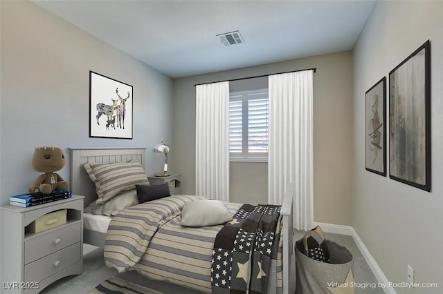 carpeted bedroom featuring visible vents and baseboards