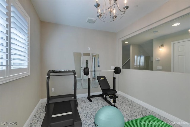 exercise area featuring visible vents, baseboards, and an inviting chandelier