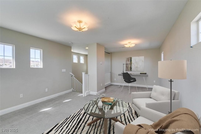 carpeted living room featuring baseboards