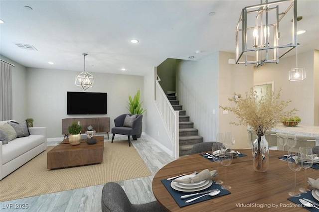 living room with recessed lighting, wood finished floors, visible vents, baseboards, and stairs