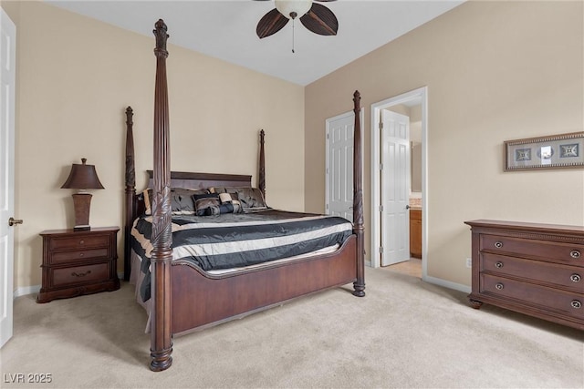 bedroom with connected bathroom, baseboards, light colored carpet, and a ceiling fan