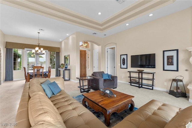 living area with baseboards, visible vents, an inviting chandelier, recessed lighting, and arched walkways