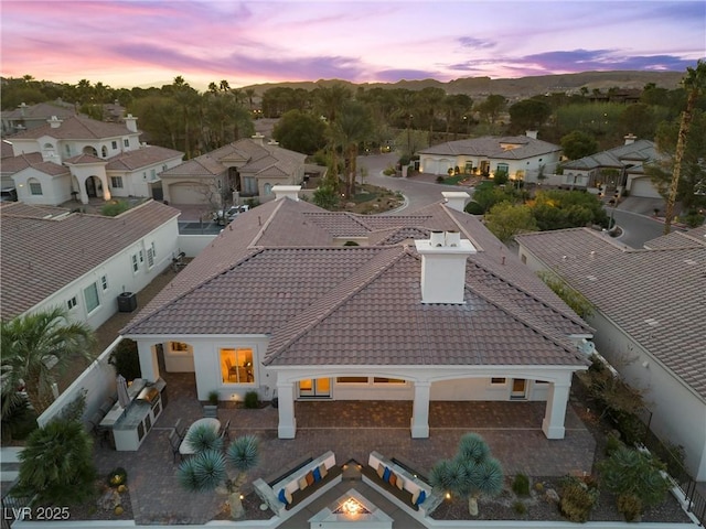 aerial view at dusk featuring a residential view