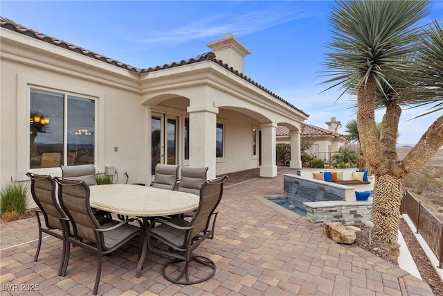 view of patio featuring outdoor dining space and fence