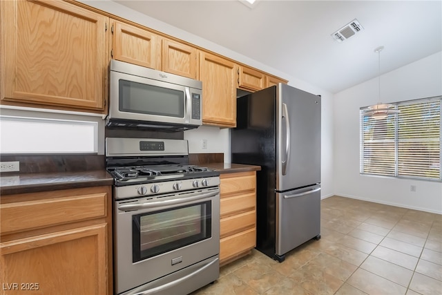 kitchen with visible vents, vaulted ceiling, hanging light fixtures, appliances with stainless steel finishes, and dark countertops