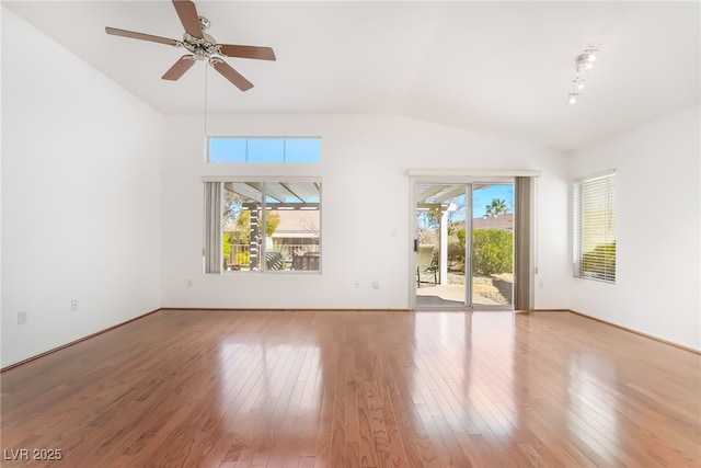 unfurnished room with lofted ceiling, wood-type flooring, and a ceiling fan