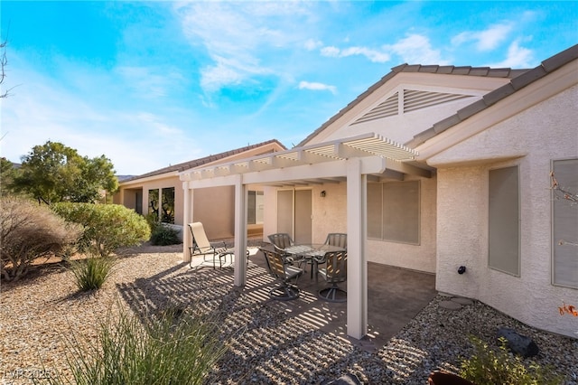 view of patio featuring outdoor dining area and a pergola