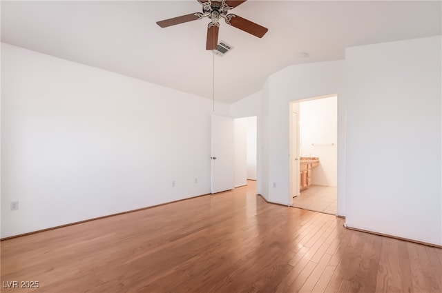 spare room with light wood finished floors, ceiling fan, visible vents, and vaulted ceiling