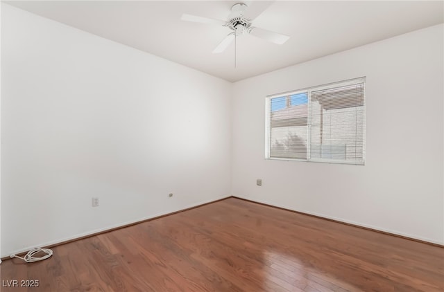 unfurnished room featuring baseboards, a ceiling fan, and wood finished floors