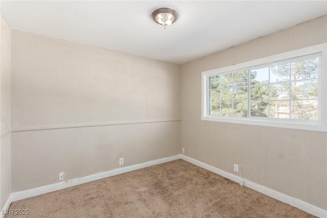 carpeted spare room with baseboards