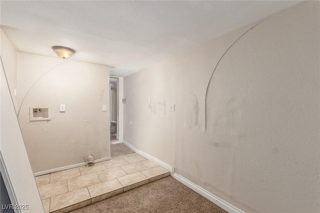 washroom featuring baseboards, washer hookup, and carpet flooring