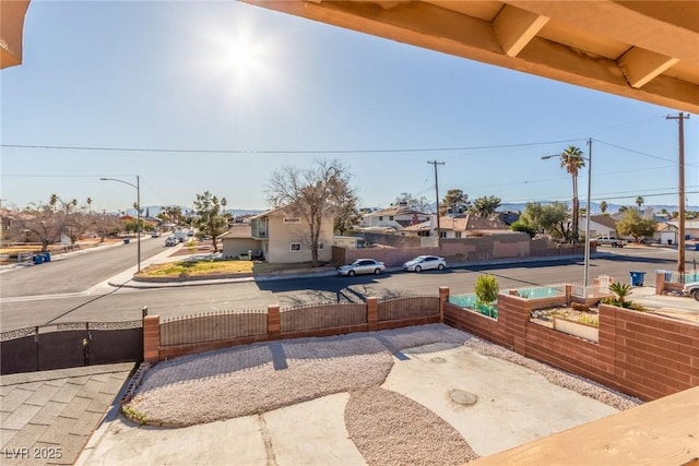 view of patio / terrace with a residential view and fence