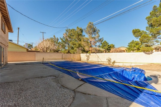 view of swimming pool featuring a patio area, a fenced backyard, and a fenced in pool