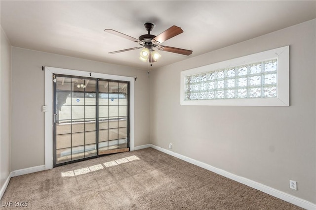 carpeted spare room featuring a healthy amount of sunlight, baseboards, and a ceiling fan