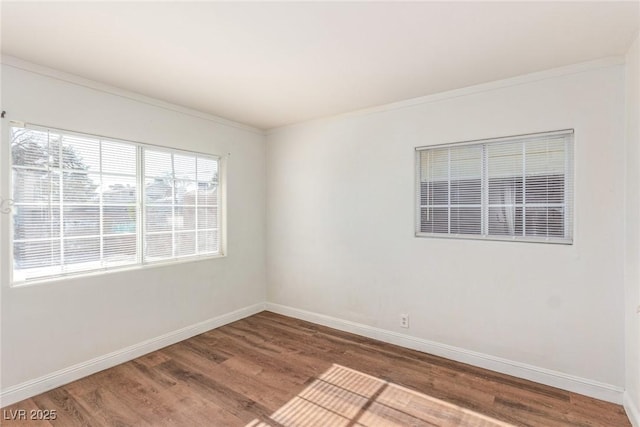 empty room with baseboards and wood finished floors