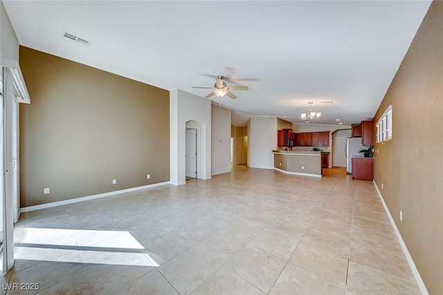 unfurnished living room featuring light tile patterned floors, visible vents, arched walkways, baseboards, and ceiling fan with notable chandelier