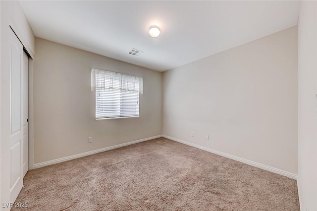 unfurnished bedroom featuring carpet floors, a closet, visible vents, and baseboards