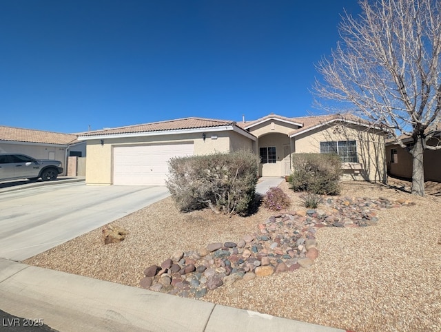 single story home featuring a garage, a tiled roof, concrete driveway, and stucco siding