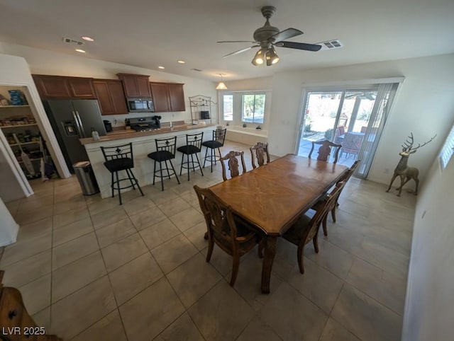 dining space with light tile patterned flooring, visible vents, vaulted ceiling, and recessed lighting