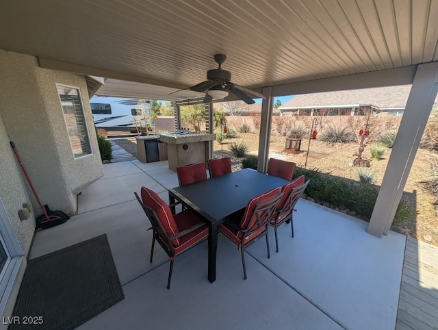 view of patio / terrace with a ceiling fan, outdoor dining space, and fence