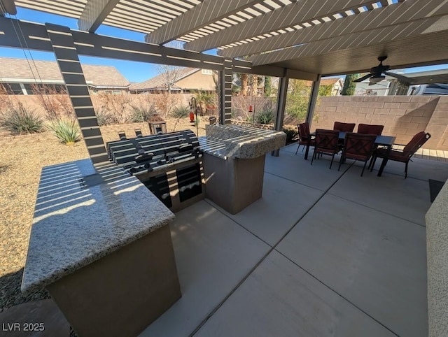 view of patio featuring outdoor dining space, fence, and a pergola