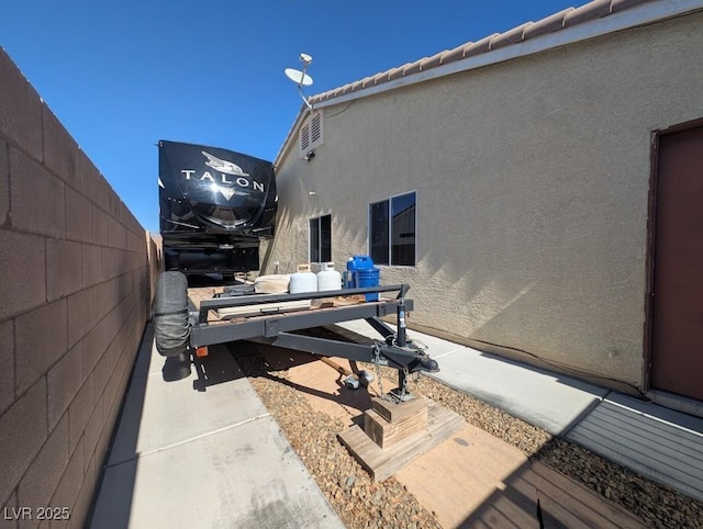 wooden deck featuring fence and a patio