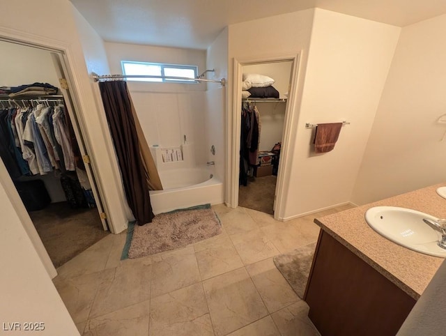 full bath featuring a spacious closet, shower / tub combo with curtain, and vanity