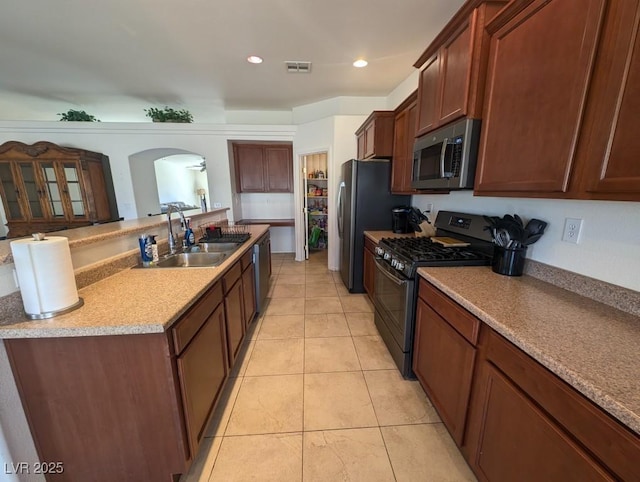 kitchen featuring light tile patterned flooring, recessed lighting, a sink, visible vents, and appliances with stainless steel finishes