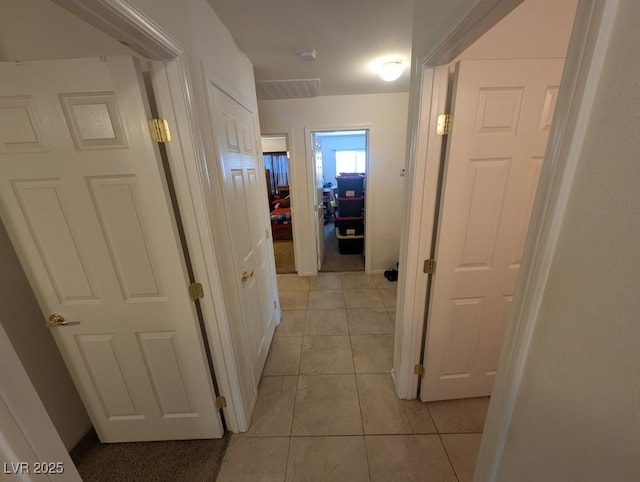 hall featuring light tile patterned flooring