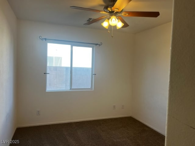 empty room featuring carpet, baseboards, and a ceiling fan