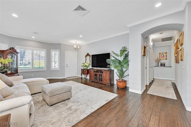 living room with ornamental molding, dark wood finished floors, visible vents, and baseboards