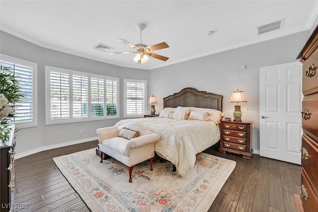 bedroom featuring dark wood-style floors, visible vents, and crown molding