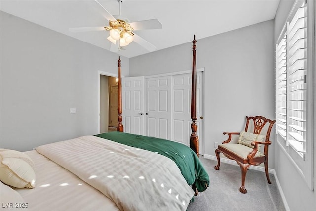 carpeted bedroom with a ceiling fan, a closet, and baseboards