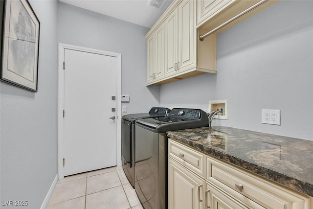 laundry room with light tile patterned floors, visible vents, baseboards, cabinet space, and washing machine and clothes dryer