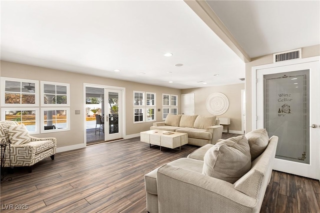 living area featuring dark wood-style floors, recessed lighting, visible vents, and baseboards