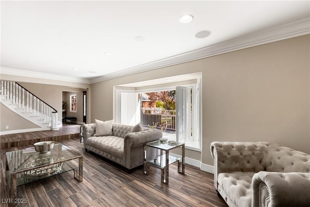 living area with ornamental molding, wood finished floors, baseboards, and stairs