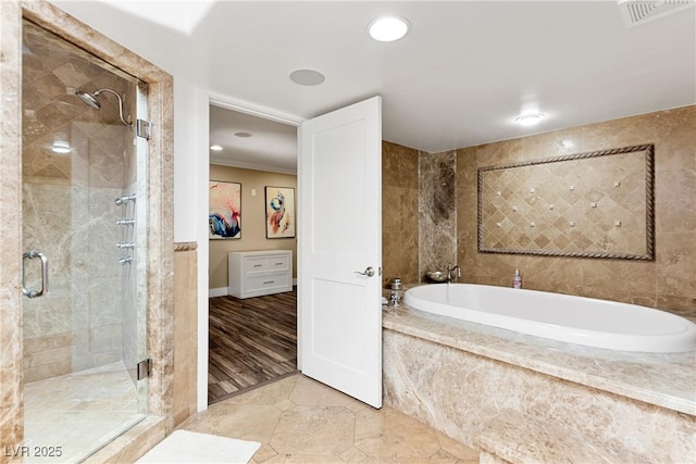 full bathroom with a stall shower, visible vents, a bath, and ornamental molding