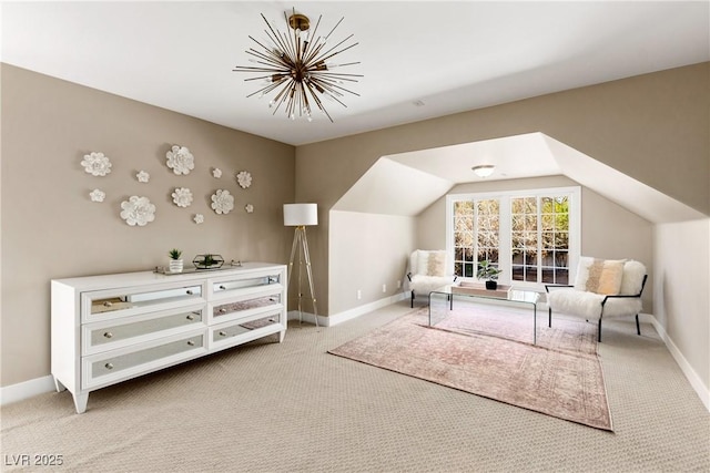 sitting room featuring light carpet, lofted ceiling, and baseboards