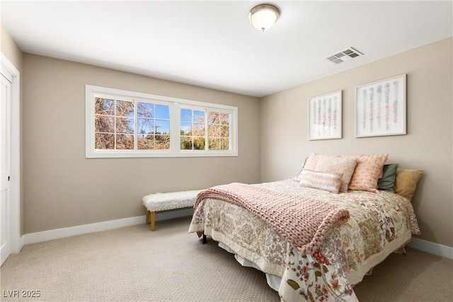 bedroom with carpet floors, a closet, visible vents, and baseboards