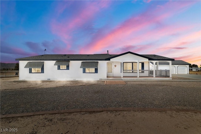 view of front of home with crawl space, driveway, and a porch