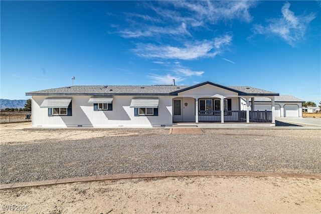 ranch-style home featuring crawl space, covered porch, a garage, and concrete driveway